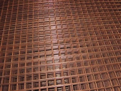 Several pieces of copper welded mesh on the ground.