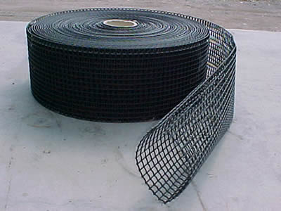 A roll of tubular oyster mesh on the  ground.